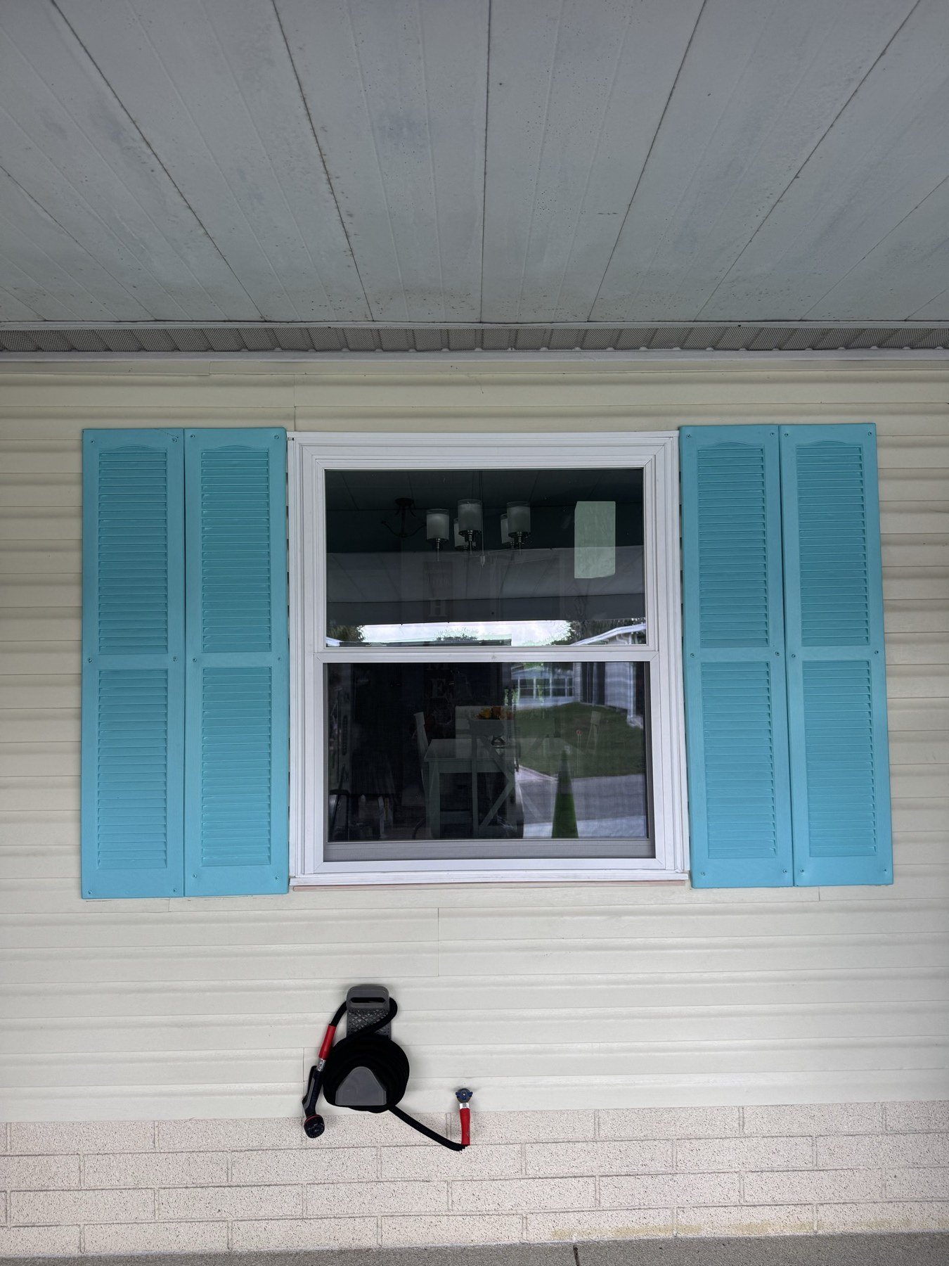 Bronze frame impact window on Florida home