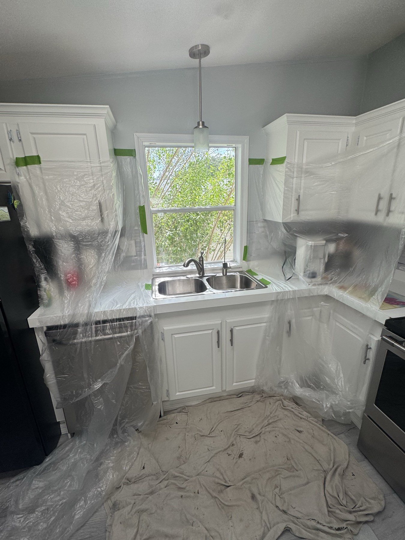 Full kitchen protected with heavy-duty plastic during installation
