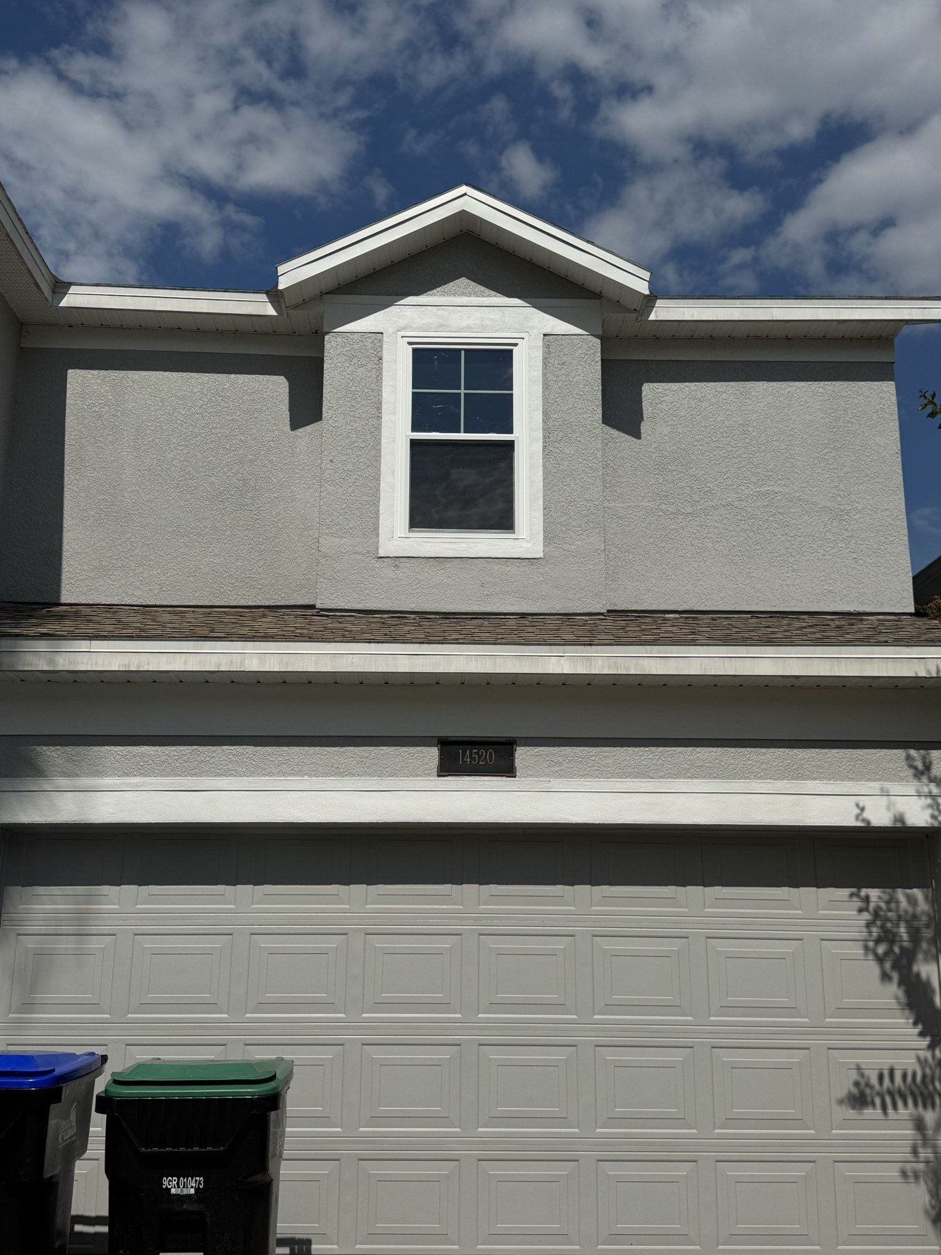 Two-story home with new impact windows — completed exterior